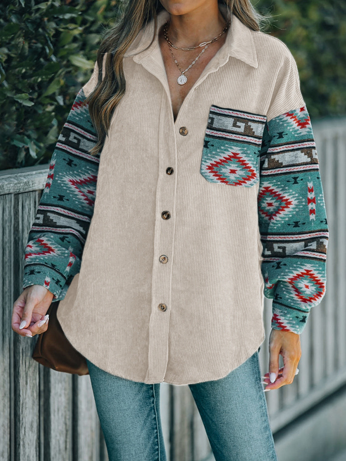 Corduroy shacket in dust storm with Aztec print sleeves and chest pocket.