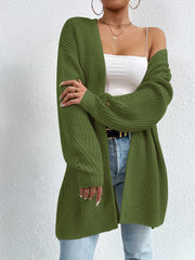 Longline knit open cardigan in green acrylic with dropped shoulders and subtle sleeve cutouts.