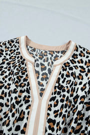Leopard print midi dress with V-neck and colorblock trim detail.