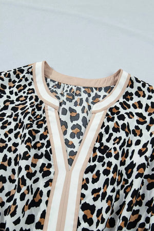 Leopard print midi dress with V-neck and colorblock trim detail.