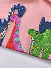 Toddler dress in blush pink with colorful dinosaur appliques and floral fabric details.