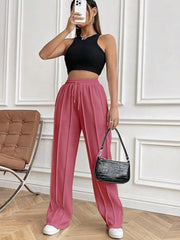 Deep Rose pleated wide-leg lounge trousers with drawstring waist and pockets.
