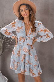 Misty Blue floral tie-front mini dress with smocked waist and tiered ruffle skirt.