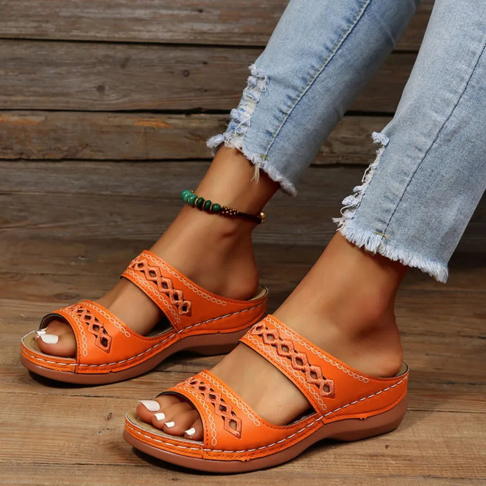 Orange embroidered strap comfort slides with a diamond pattern detail.