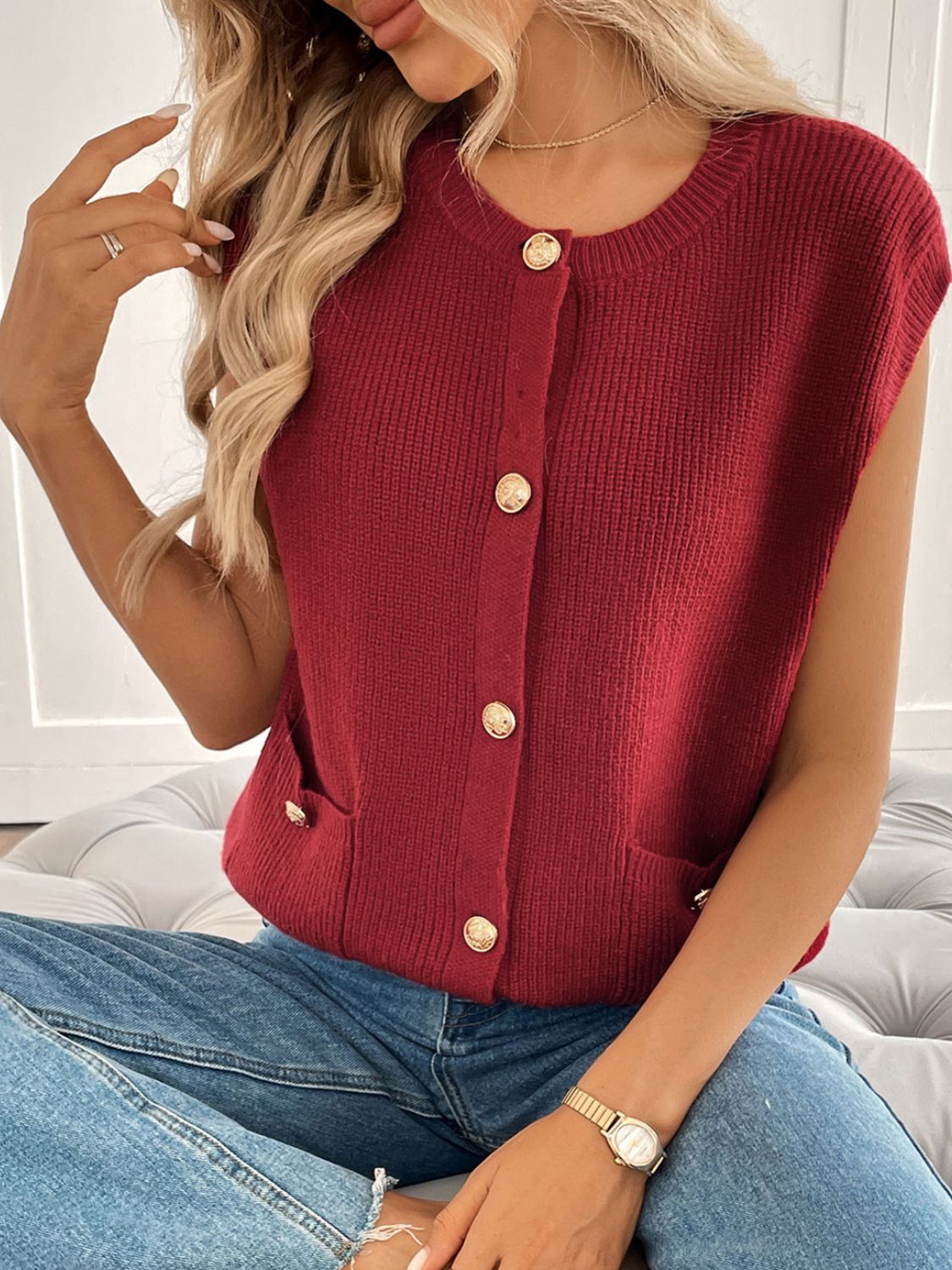 Burgundy ribbed knit vest with gold buttons and pocket details.