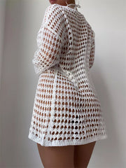 White crochet knit cover-up with openwork pattern and long sleeves.