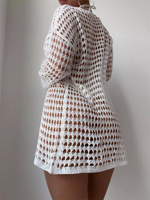 White crochet knit cover-up with openwork pattern and long sleeves.