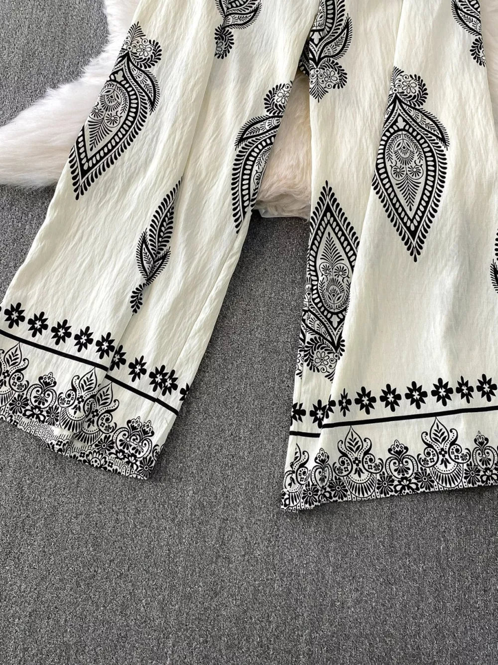 White wide leg romper with black paisley and floral print details