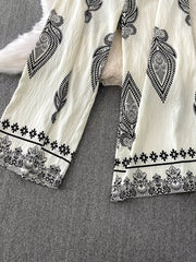 White wide leg romper with black paisley and floral print details