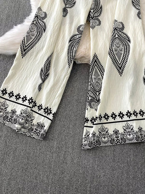 White wide leg romper with black paisley and floral print details