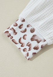 White waffle knit polo with leopard print cuff detail