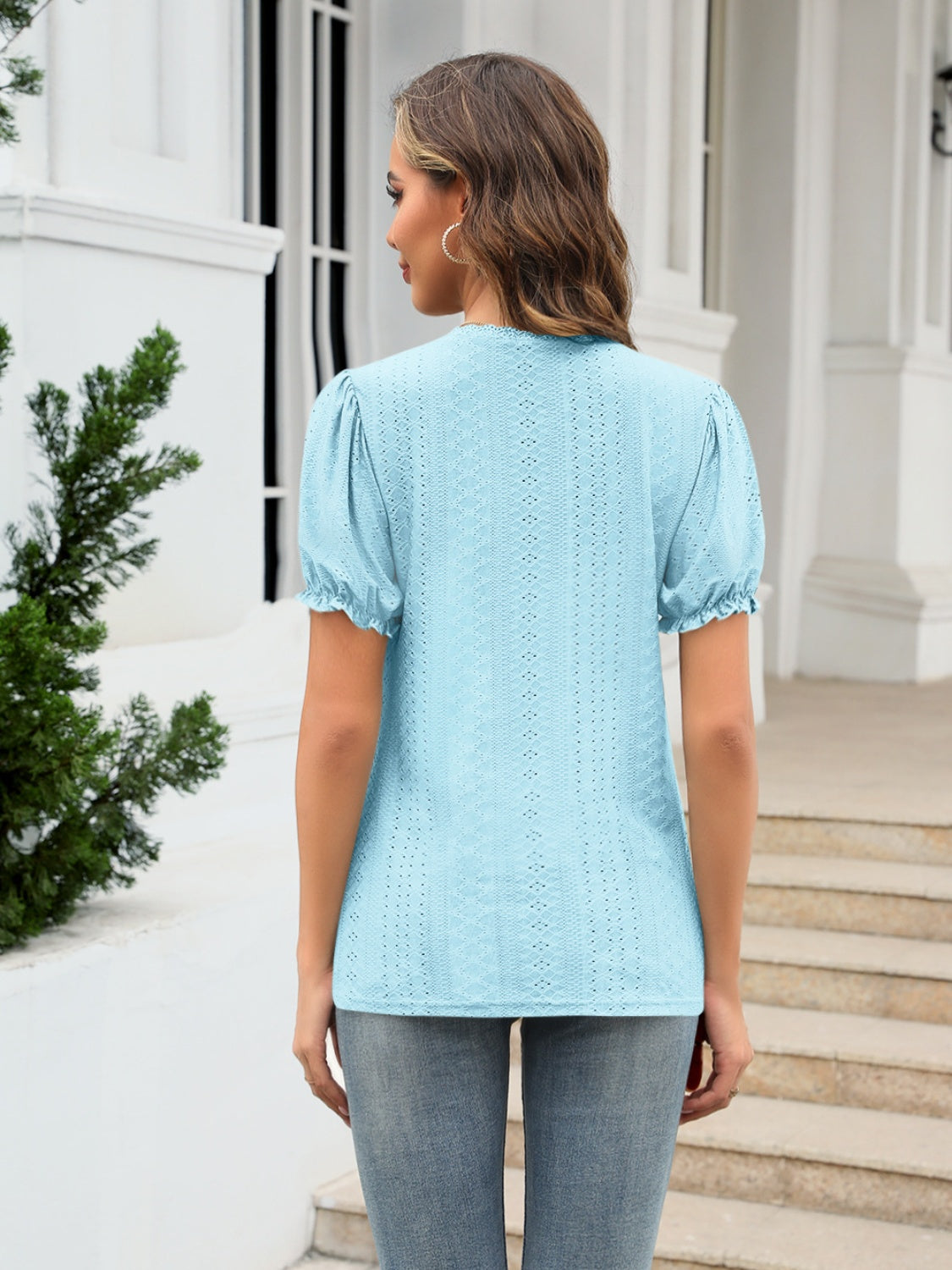 Light blue eyelet puff sleeve v-neck blouse with ruffled cuffs