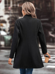 Black wool blend coat with a sculpted flare hem and buttoned front, shown from the back.