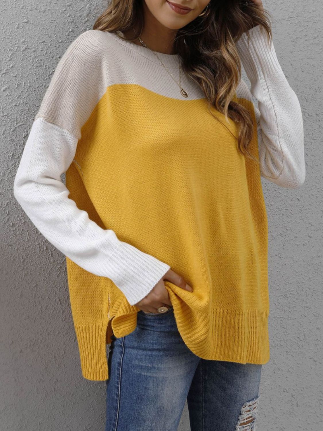 Colorblock crewneck knit sweater in gold and white with side slits