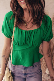 Green ruched peplum shirt with puff sleeves and a square neckline.