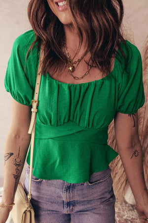 Green ruched peplum shirt with puff sleeves and a square neckline.