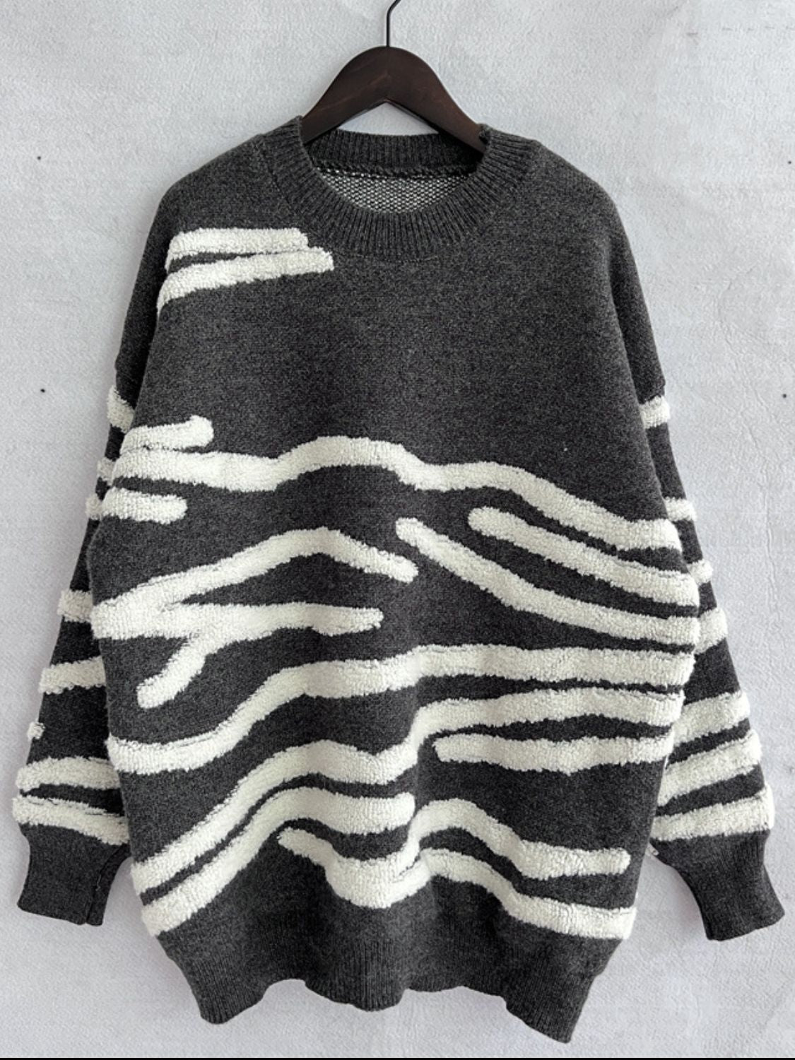 Dark gray acrylic crewneck sweater with textured white stripe pattern