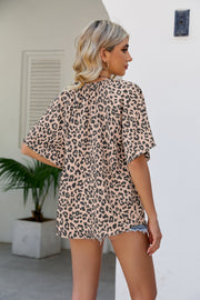 Tan leopard print v-neck blouse with short sleeves and a relaxed fit.