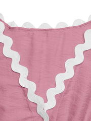 Pink maternity romper cover-up with white scalloped trim detail