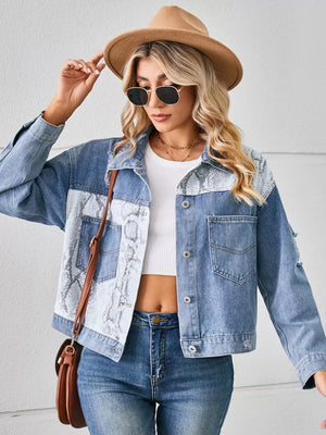 Denim trucker jacket with python pattern panels and pockets.