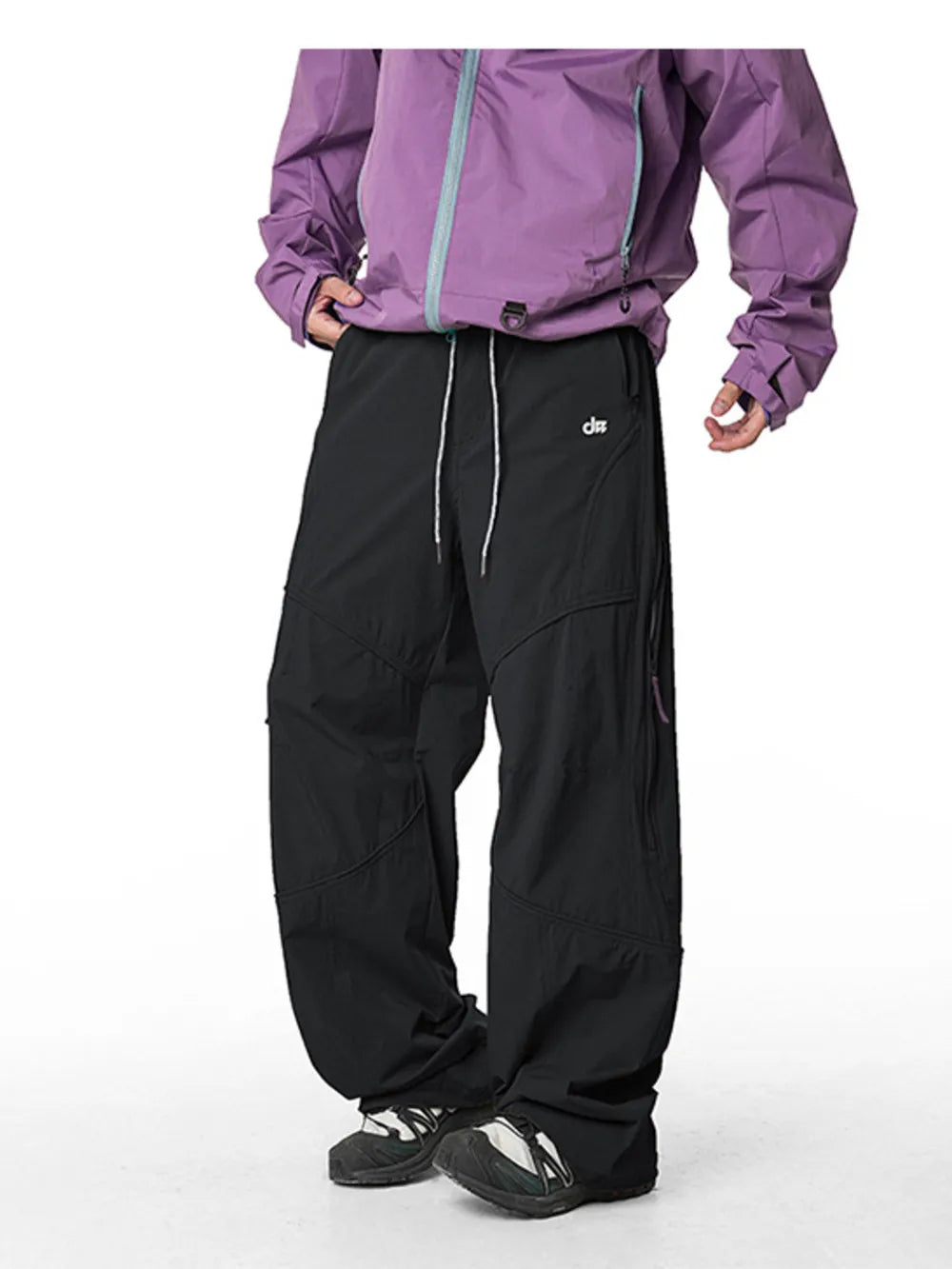 Relaxed fit black cargo pants with white drawstring and side zip pockets.