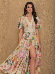 Tropical floral print maxi dress with lace trim, button front, puff sleeves, and high slit.