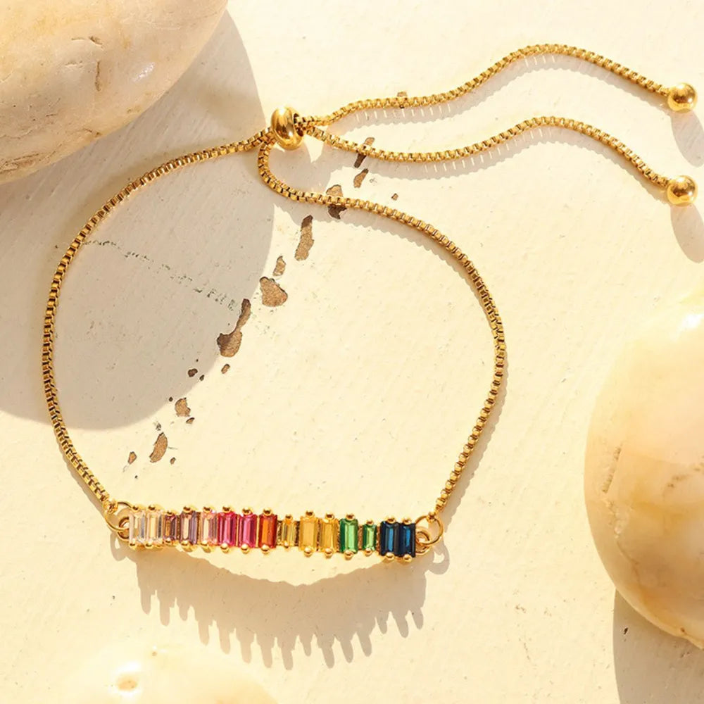 Gold bar bracelet with rainbow baguette cubic zirconia and adjustable clasp
