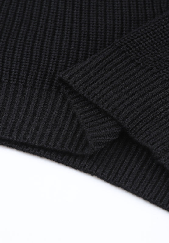 Black knit v-neck pullover sweater with ribbed texture and cuff detail.