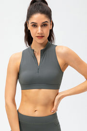 High-neck zip-front active crop top in grey, sleeveless with a cropped fit.