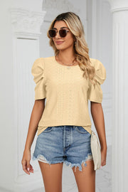 Yellow perforated sleeve volume blouse with round neckline and puff sleeves.