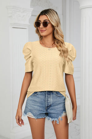Yellow perforated sleeve volume blouse with round neckline and puff sleeves.