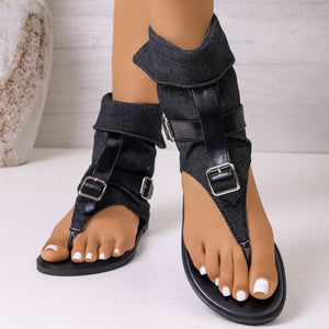 Black denim-accented buckle sandals with ankle cuff and thong strap.