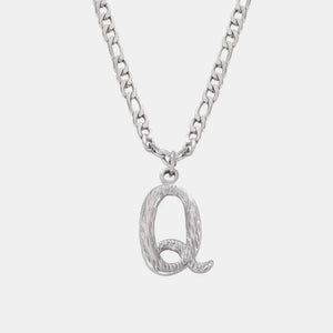 Silver initial pendant necklace with textured letter Q and curb chain.