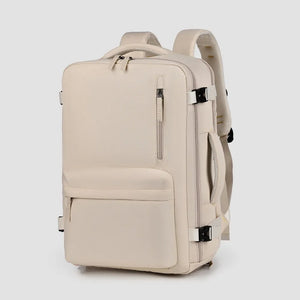 Beige travel backpack with zippered front pocket and side handle.