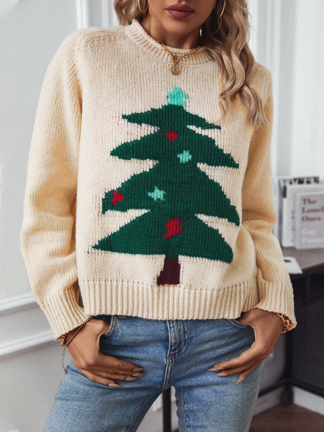 Cream acrylic sweater with a green Christmas tree intarsia knit pattern and red and blue ornaments.
