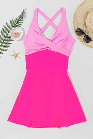 Hot pink one-piece swimsuit with cross-front detail and skirted bottom.