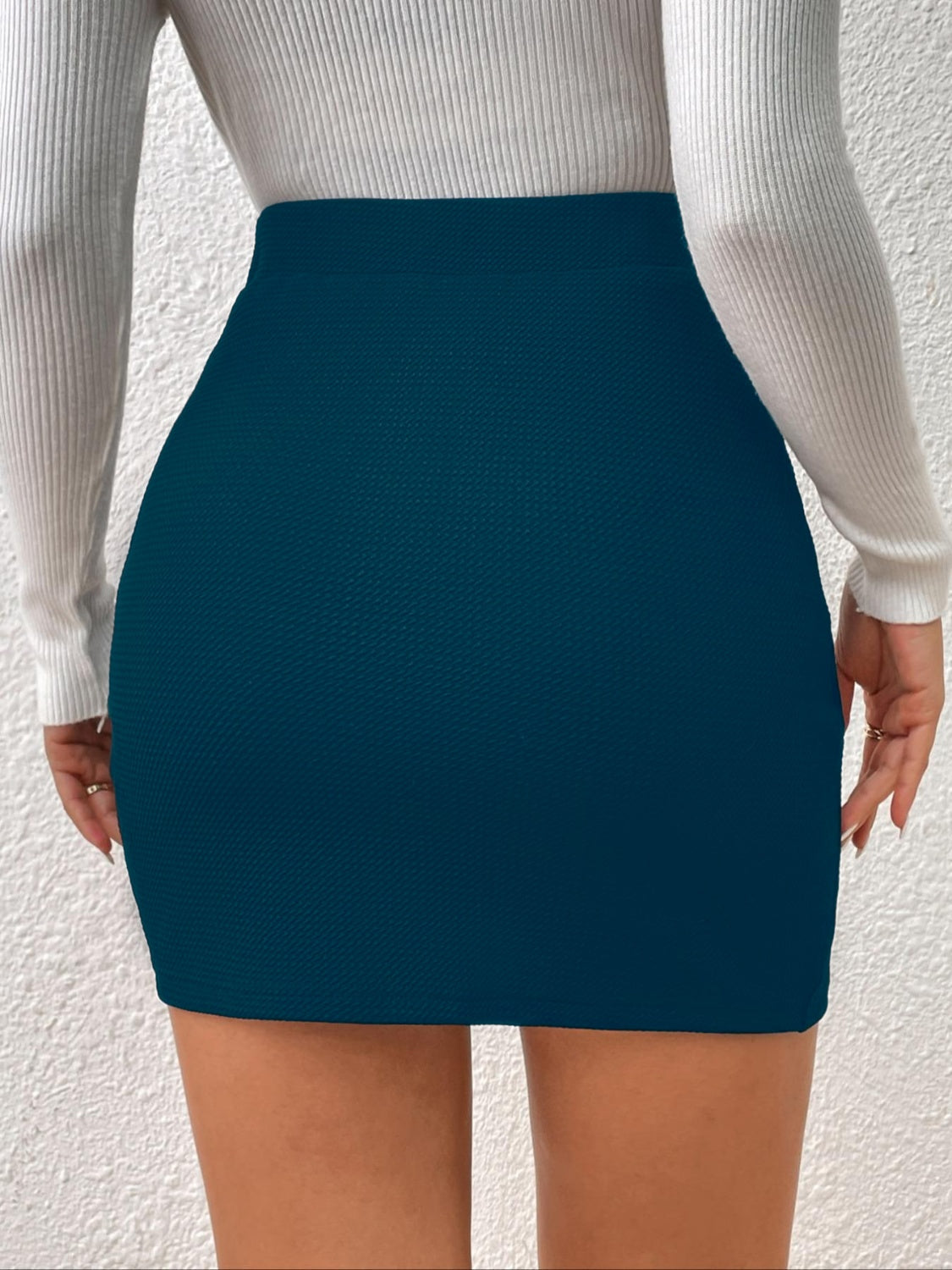 Textured wrap mini skirt in peacock blue with a bodycon fit.