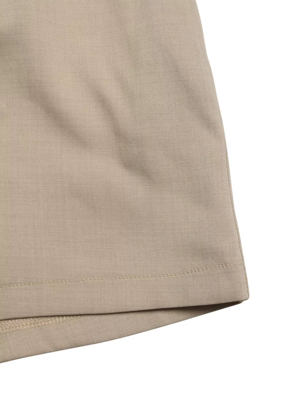 V-neck tied waist romper in beige, showing fabric texture and hem detail.