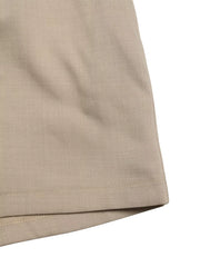 V-neck tied waist romper in beige, showing fabric texture and hem detail.