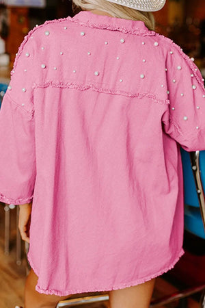 Fuchsia pink utility jacket with pearl embellishments and raw edges.