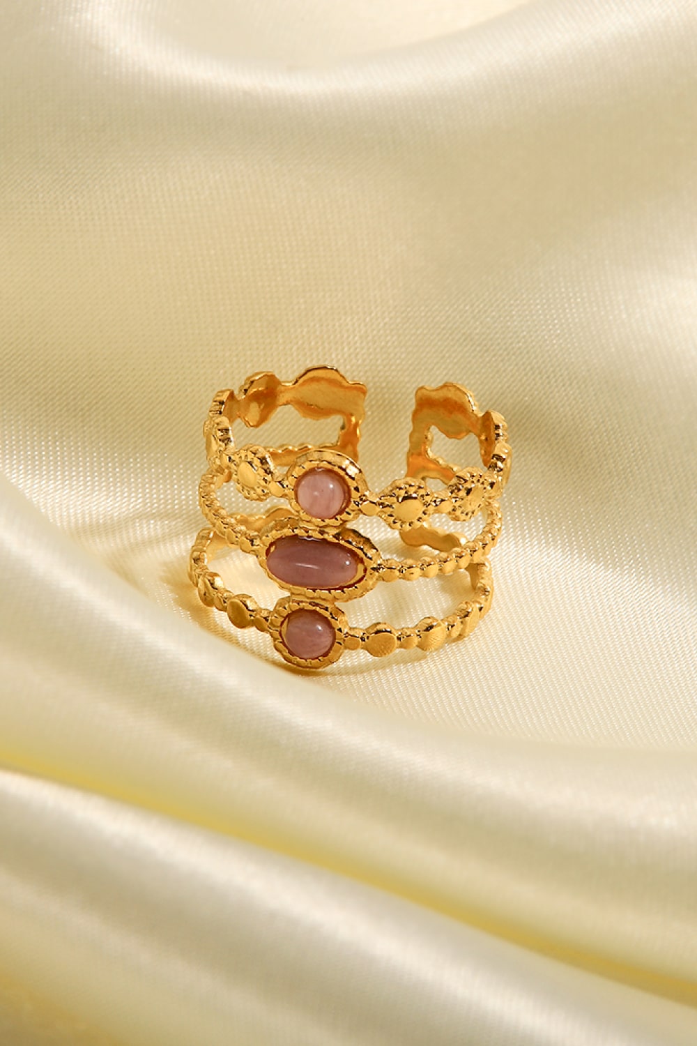 Gold triple stone openwork ring with pink stones and beaded detail