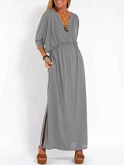 Gray V-neck maxi dress with dolman sleeves, elastic waist, and side slits.