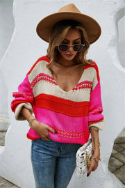 Deep plunge stripe knit pullover with pink, red, and beige stripes.