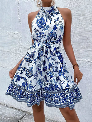 Floral print halter dress with tie waist and ruffled hem in royal blue.