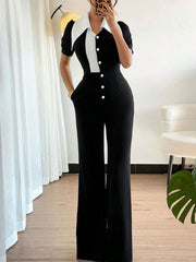 Button-down wide leg jumpsuit in black and white with short sleeves and a pointed collar.