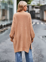 Camel open-stitch waffle knit duster cardigan with side slits and balloon sleeves.