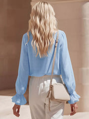 Sky blue maternity shirt with ruffled V-neck and long sleeves.