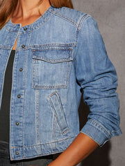 Light wash denim utility jacket with band collar, chest pocket, and button front.