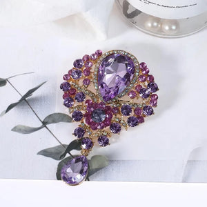 Regal teardrop brooch with purple crystals and gold alloy setting