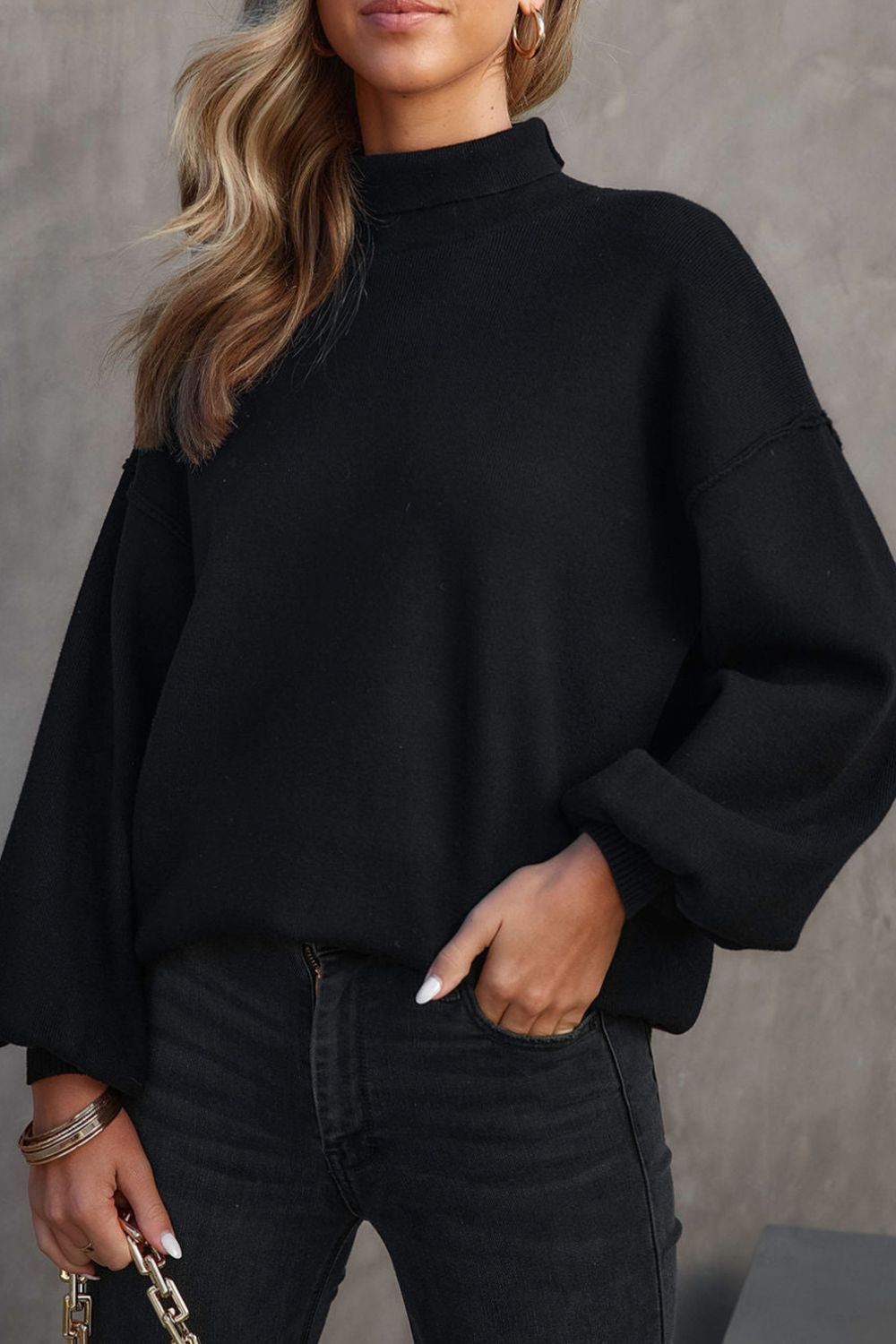 Black knit sweater with mock neck and balloon sleeves
